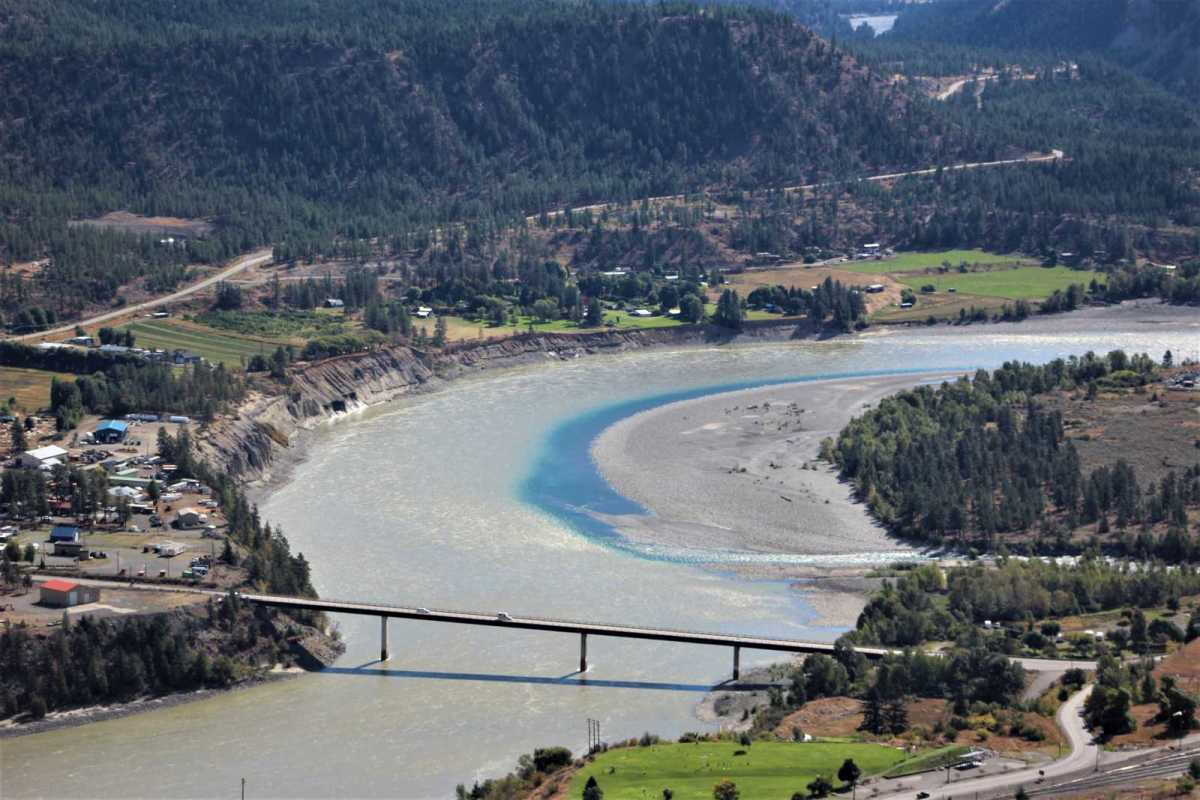 Confluence of the blue waters of Cayoosh Creek with the muddy brown Fraser River